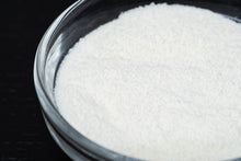 Load image into Gallery viewer, Close up of Collagen Companion fine collagen peptide powder in glass bowl black background.