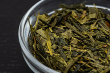 Load image into Gallery viewer, Close up of Gunnamatta Green tea leaves in glass bowl. Organic. Loose Leaf.