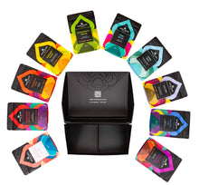 Load image into Gallery viewer, Aerial view of open Discovery Box with 10 tea pouches arranged in a rainbow pattern around lying down around the box. Luxury organic loose leaf teas and collagen peptides. Satin finish black box with 9 pouches of loose leaf tea and 1 pouch of collagen peptides powder. Gift Pack. Loose leaf tea gift pack.