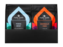 Load image into Gallery viewer, Discovery Box with luxury organic loose leaf teas and collagen peptides. Satin finish black box with 9 pouches of loose leaf tea and 1 pouch of collagen peptides powder. Gift Pack. Loose leaf tea gift pack. Open front view. 10 pouches standing in 2 rows of 5. Yowie Mint and Radiant Glow at the front
